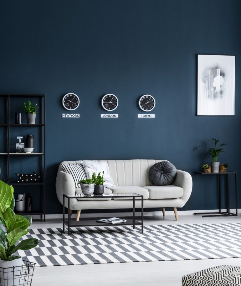 white-sofa-coffee-table-clocks-on-the-grey-wall-an-K3L9PER-1-scaled.jpg